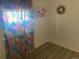 Cozy bedroom featuring light from window with colorful patterned curtains at 7170 W Mississippi W Ave, Lakewood, CO 80226