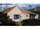 A charming single-story home featuring a brown roof, tan siding, and a cozy sunroom; a delightful exterior with a warm appeal at 7170 W Mississippi W Ave, Lakewood, CO 80226
