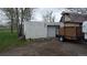 A detached single-car garage and trailer parked outside, with a yard adjacent, offering convenient storage and parking at 7170 W Mississippi W Ave, Lakewood, CO 80226