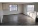 Bright living room featuring wood-look flooring, white walls, and natural light from the large windows at 7170 W Mississippi W Ave, Lakewood, CO 80226