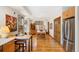 Well-lit dining room with hardwood floors, custom cabinets, stainless appliances, and decorative windows at 2595 S Adams St, Denver, CO 80210