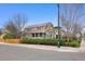 Attractive two-story home with a welcoming front porch, manicured bushes, and a beautiful blue sky at 2595 S Adams St, Denver, CO 80210