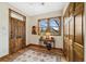 Elegant foyer featuring a wooden front door, stylish rug, and a convenient closet at 2595 S Adams St, Denver, CO 80210