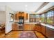 Cozy kitchen with custom cabinets, granite counters, stainless appliances, hardwood floors, and decorative windows at 2595 S Adams St, Denver, CO 80210