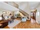 Spacious living room featuring hardwood floors, a staircase, and an upper level landing overlooking the downstairs space at 2595 S Adams St, Denver, CO 80210