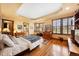 Spacious main bedroom with hardwood floors, tray ceilings, decorative windows, and a walk-in closet at 2595 S Adams St, Denver, CO 80210
