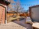 Private backyard with a brick patio, planter boxes, seating, and a swing set at 1444 Fairfax St, Denver, CO 80220