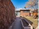 Backyard view of the home with brick patio, planter boxes, and mature landscaping at 1444 Fairfax St, Denver, CO 80220