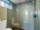 Updated shower with stylish tile surround, glass door, and modern fixtures at 1444 Fairfax St, Denver, CO 80220