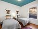 Bedroom with two twin beds, unique wall decor, and a blue ceiling at 1444 Fairfax St, Denver, CO 80220