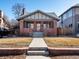 Charming brick home with a welcoming front porch and well-maintained lawn at 1444 Fairfax St, Denver, CO 80220