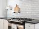 A close up view of the gas stovetop and black countertops in the kitchen at 1444 Fairfax St, Denver, CO 80220