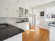 Bright kitchen with white cabinetry and classic subway tile backsplash at 1444 Fairfax St, Denver, CO 80220