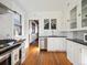 Bright kitchen with white cabinets, subway tile backsplash, and stainless steel appliances at 1444 Fairfax St, Denver, CO 80220