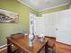 Office with a globe, desk, hardwood floors, and large windows at 1444 Fairfax St, Denver, CO 80220