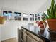 Bright sunroom with many windows and a stainless steel countertop on drawers at 1444 Fairfax St, Denver, CO 80220