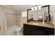Bathroom with tiled walls, tub, shower, vanity, modern light fixture, and marble countertop at 2222 N Washington St, Denver, CO 80205