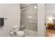 Bathroom features a tiled shower with glass doors, a toilet, and neutral wall paint at 2222 N Washington St, Denver, CO 80205