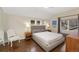 Relaxing bedroom with a plush king bed, hardwood floors, and natural light from large windows at 2222 N Washington St, Denver, CO 80205