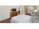 Spacious bedroom featuring a large TV, wood floors, and a glimpse into the connected bathroom at 2222 N Washington St, Denver, CO 80205