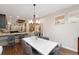 An elegant dining space features a modern light fixture and hardwood flooring at 2222 N Washington St, Denver, CO 80205