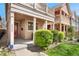 Inviting covered front porch with green landscaping and a modern security system at 2222 N Washington St, Denver, CO 80205
