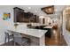 Stylish kitchen features a breakfast bar, dark cabinets, stainless appliances, and an open concept design at 2222 N Washington St, Denver, CO 80205