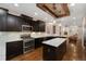 Contemporary kitchen featuring dark cabinetry, stainless steel appliances, and an open floor plan design at 2222 N Washington St, Denver, CO 80205