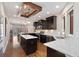Modern kitchen with dark cabinets, stainless steel appliances, and a marble island, flowing into dining area at 2222 N Washington St, Denver, CO 80205