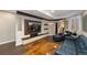 Open concept living room with a large flat screen tv and a wood beam design at 2222 N Washington St, Denver, CO 80205