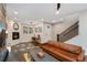 Bright living room with hardwood floors, fireplace, and staircase leading to the upper level at 2222 N Washington St, Denver, CO 80205