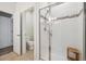 A full bath features a glass enclosed shower, mosaic accents, bright lighting, and a separate toilet behind a door at 538 S Upham St, Lakewood, CO 80226