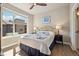 Bright bedroom with ceiling fan, wooden floors, and a large window for natural light at 538 S Upham St, Lakewood, CO 80226