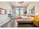 This bright bedroom has large windows, a modern ceiling fan, and a stylish color scheme, creating a cozy ambiance at 538 S Upham St, Lakewood, CO 80226
