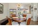 A formal dining room has a decorative light fixture and leads to an open entryway and a view to the kitchen at 538 S Upham St, Lakewood, CO 80226