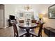 This beautiful dining room is enhanced by a stylish light fixture and is open to the home's living area at 538 S Upham St, Lakewood, CO 80226