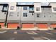 Townhome exterior with 3 orange garages, a gray exterior and lots of windows at 538 S Upham St, Lakewood, CO 80226