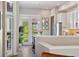 Modern kitchen with stainless steel appliances, white cabinets, and breakfast bar at 538 S Upham St, Lakewood, CO 80226