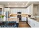 Bright kitchen featuring white cabinets, stainless steel appliances, and island at 538 S Upham St, Lakewood, CO 80226