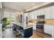 Modern kitchen with stainless steel appliances, island, and open layout to balcony at 538 S Upham St, Lakewood, CO 80226