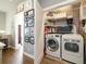 Convenient laundry room with modern washer and dryer, shelving and storage space at 538 S Upham St, Lakewood, CO 80226