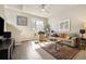 Bright living room with hardwood floors, large window, and comfortable furnishings at 538 S Upham St, Lakewood, CO 80226