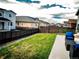 Lush backyard view features a well-maintained lawn, privacy fence, and outdoor seating at 121 S Vandriver Way, Aurora, CO 80018