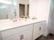 Bathroom featuring a vanity with dual sinks and a large mirror, plus walk-in shower at 121 S Vandriver Way, Aurora, CO 80018