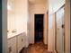 Bathroom with dual vanity sink, large mirror, walk-in shower, and closet at 121 S Vandriver Way, Aurora, CO 80018