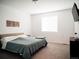 Bright bedroom featuring neutral walls, a comfortable bed and an entertainment center at 121 S Vandriver Way, Aurora, CO 80018