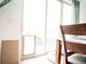 Bright dining area features a sliding glass door with pet access and light wood table at 121 S Vandriver Way, Aurora, CO 80018