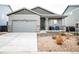 Charming single-story home with a two-car garage and a cozy front porch with stone accents at 121 S Vandriver Way, Aurora, CO 80018