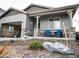 Charming single-story home with a two-car garage and a cozy front porch with stone accents at 121 S Vandriver Way, Aurora, CO 80018