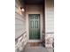 Close up of a stylish front door with stone accents and modern exterior lighting at 121 S Vandriver Way, Aurora, CO 80018